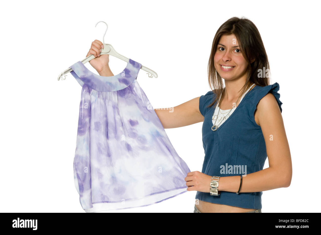 Young woman holding dress on hanger Banque D'Images