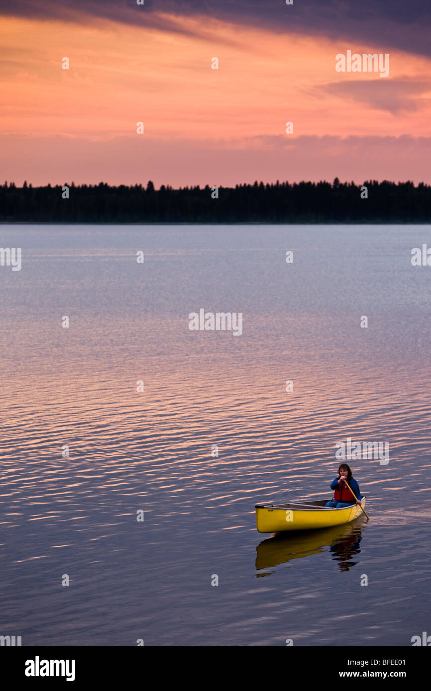 Canoë sur le lac Audy au coucher du soleil dans le parc national du Mont-Riding, Manitoba, Canada Banque D'Images