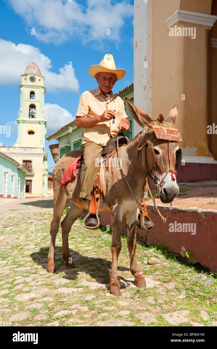 Homme sur Donkey fumer un cigare à Trinidad, Cuba Banque D'Images