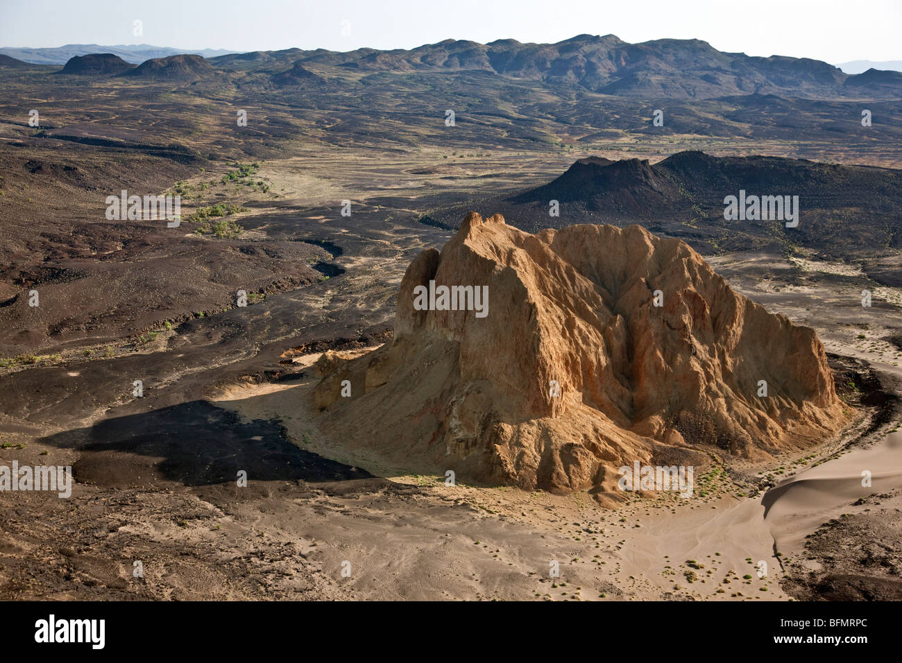 L'effondrement d'un volcan éteint, connu comme Aruba Rock, est entouré par les sorties de roche de lave noire sur le bord de la vallée de la Suguta. Banque D'Images