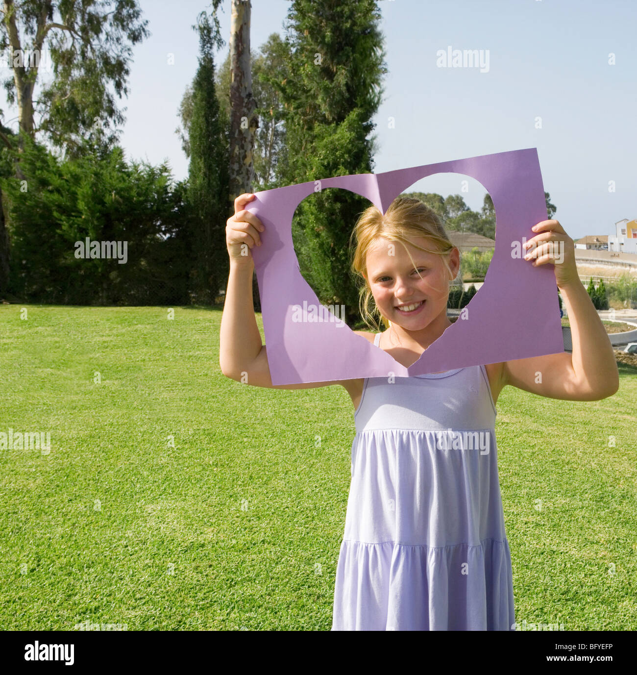 Young Girl holding paper heart frame Banque D'Images