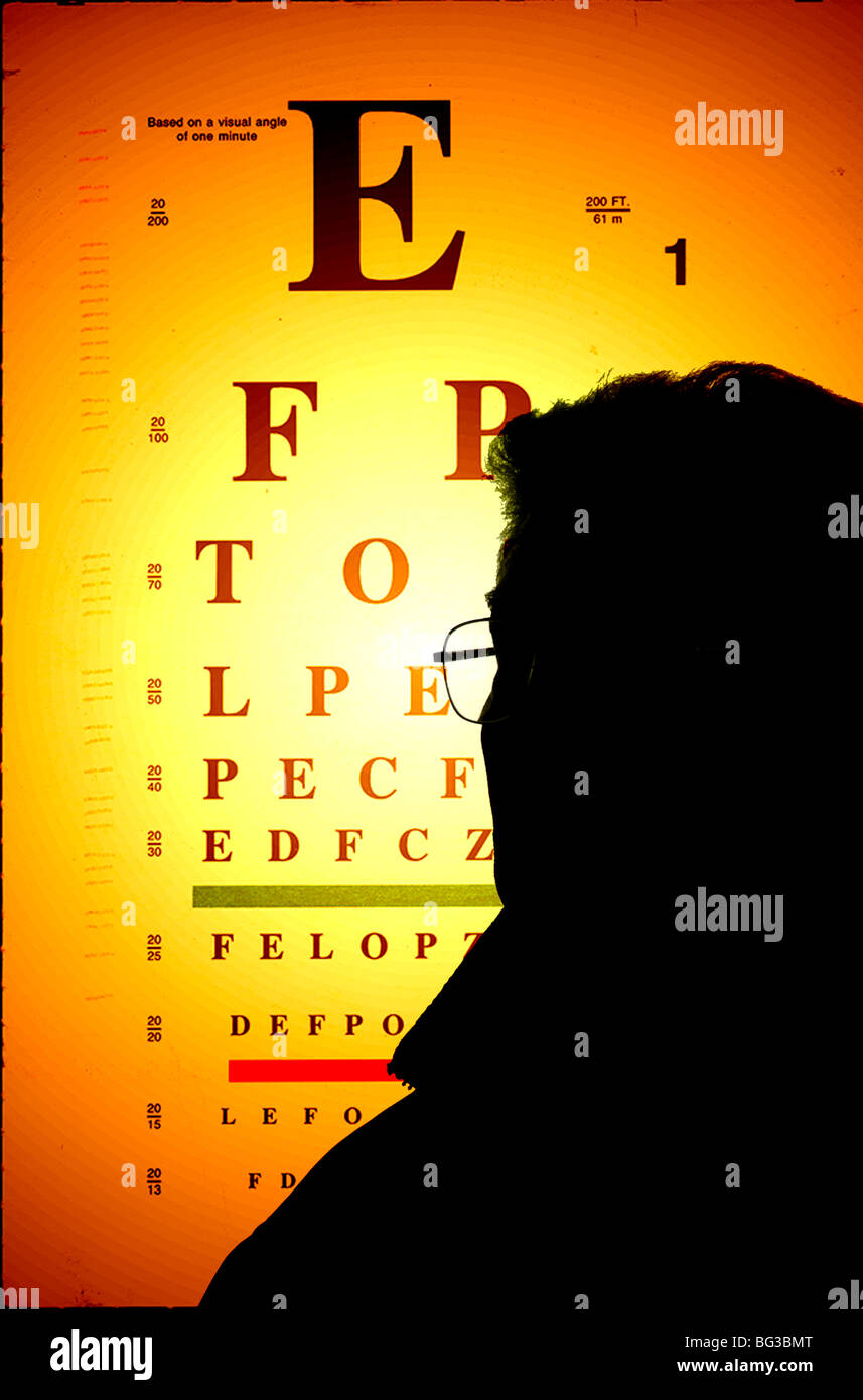Silhouette of man studying eye chart Banque D'Images