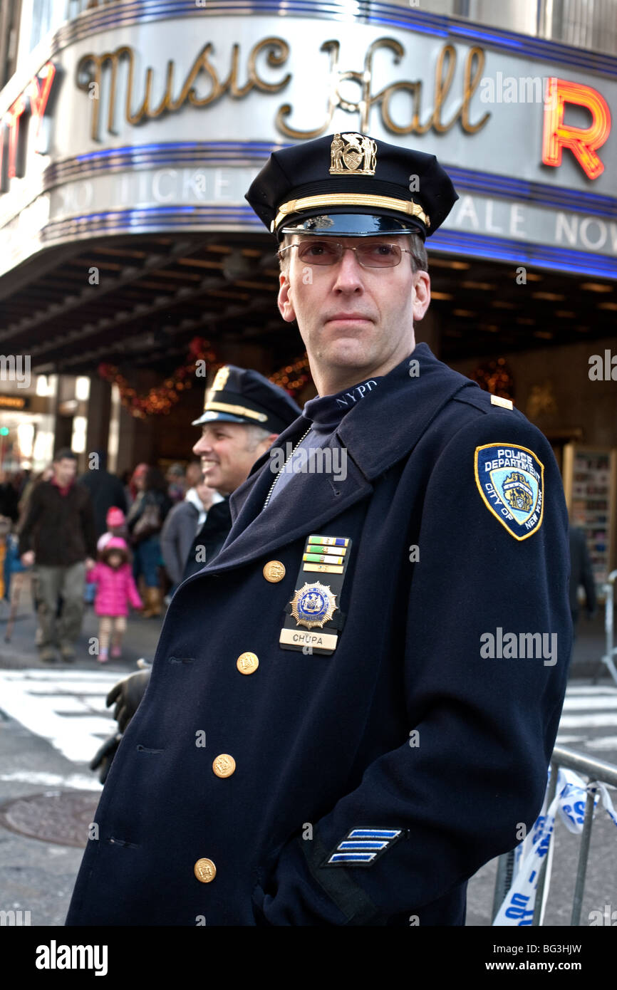 Agent de police de New York décorées supervise le contrôle du trafic aérien près de Radio City Music Hall au cours de la ruée de Noël à Manhattan Banque D'Images