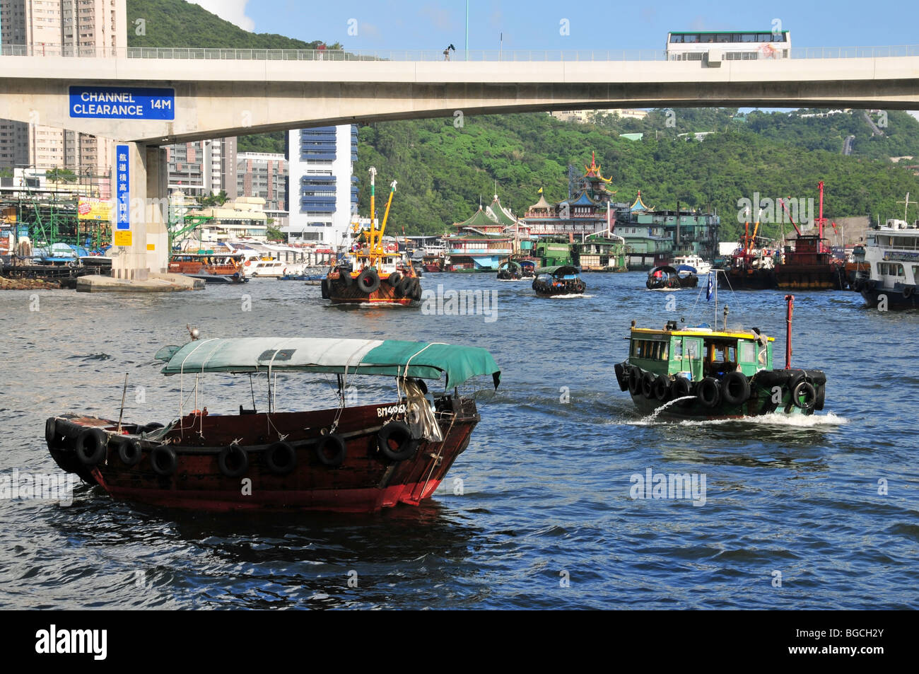 Bateau de pêche en passant un sampan sampan touristiques, amarré près du pont Ap Lei Chau, Aberdeen Harbour, Hong Kong, Chine Banque D'Images
