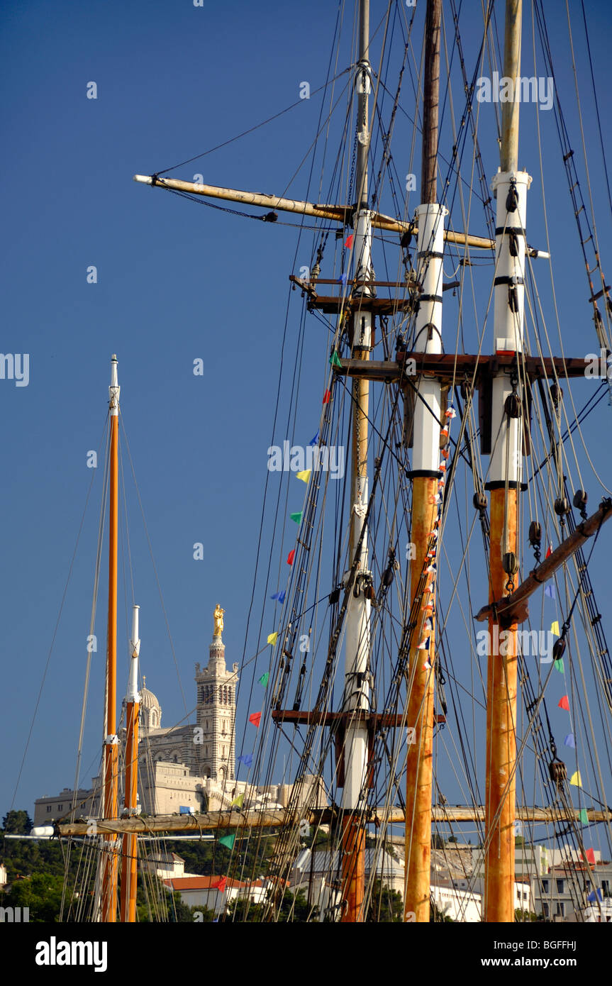 Église notre-Dame de la Garde ou Cathédrale à travers des mâts en bois de bateaux d'époque dans le Vieux Port ou Port, Marseille ou Marseille, Provence France Banque D'Images