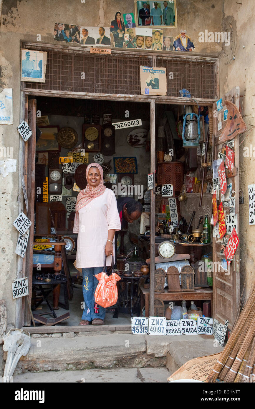 Zanzibar, Tanzanie. Un nouveau client de quitter une ville de pierre Curio-Souvenir Shop. Obama photos au-dessus de la porte. Banque D'Images