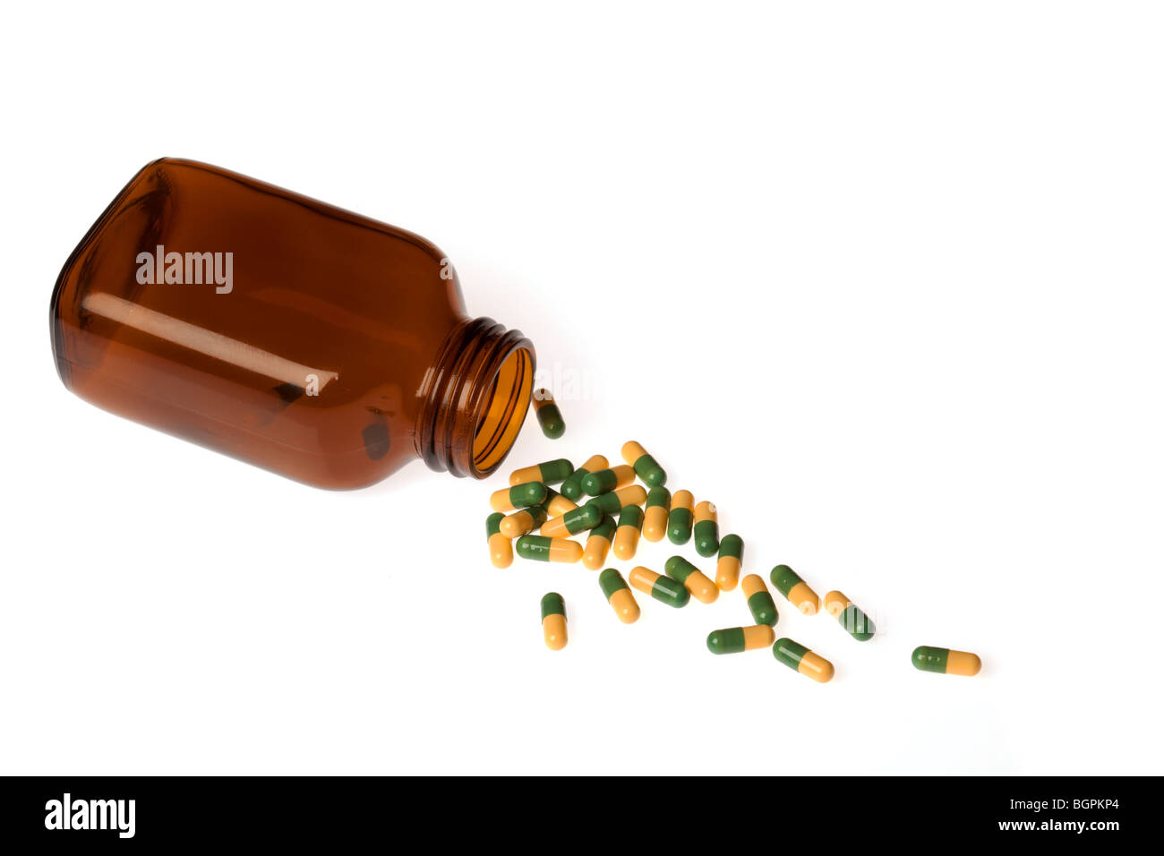 Une bouteille de pilules avec pills spilling out Banque D'Images
