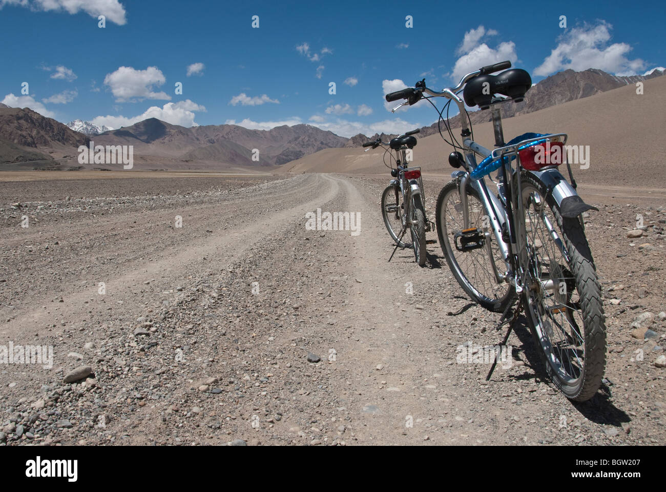 Deux vélos sur le côté d'une route déserte dans le Pamir, Tadjikistan Plateau Banque D'Images