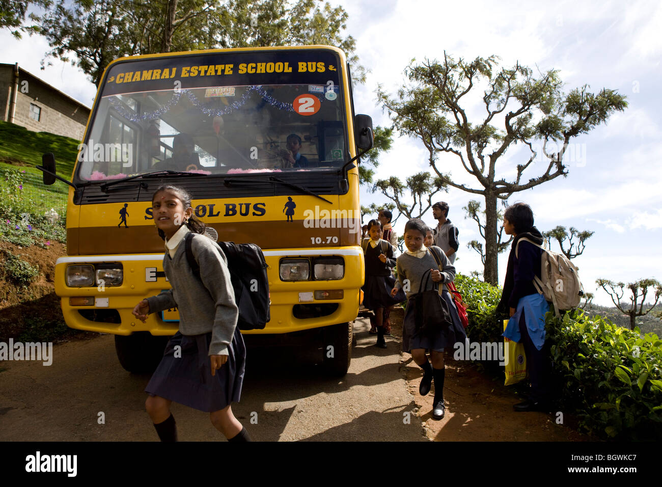 Les enfants indiens arrivant à l'école en autobus scolaire Banque D'Images