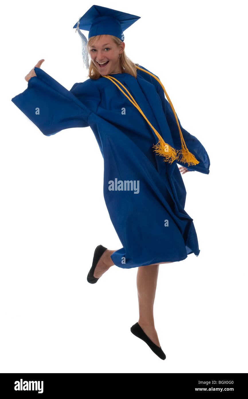 Teen girl in a graduation gown jumping for joy Banque D'Images