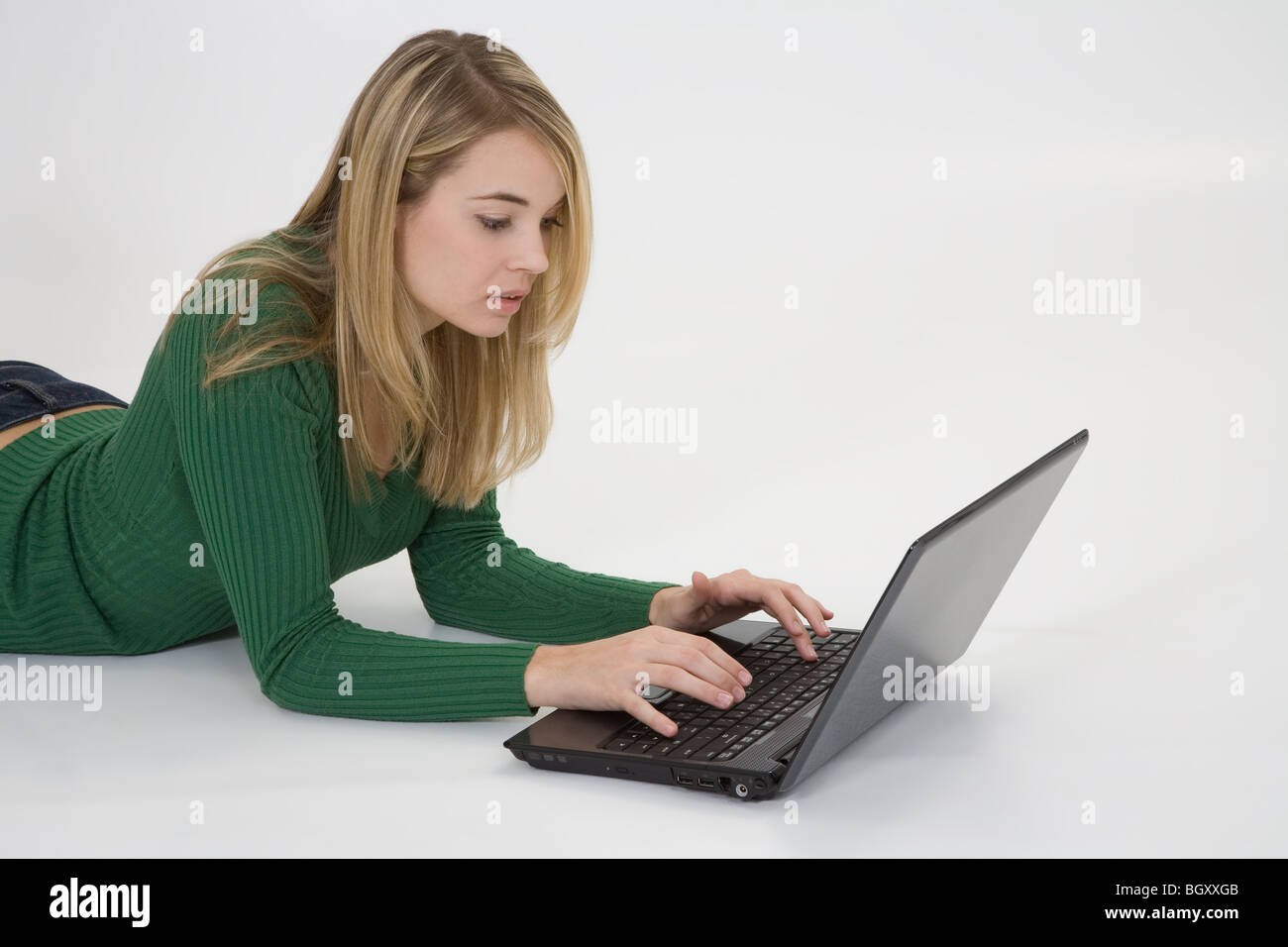 Young woman working on laptop computer on white background Banque D'Images