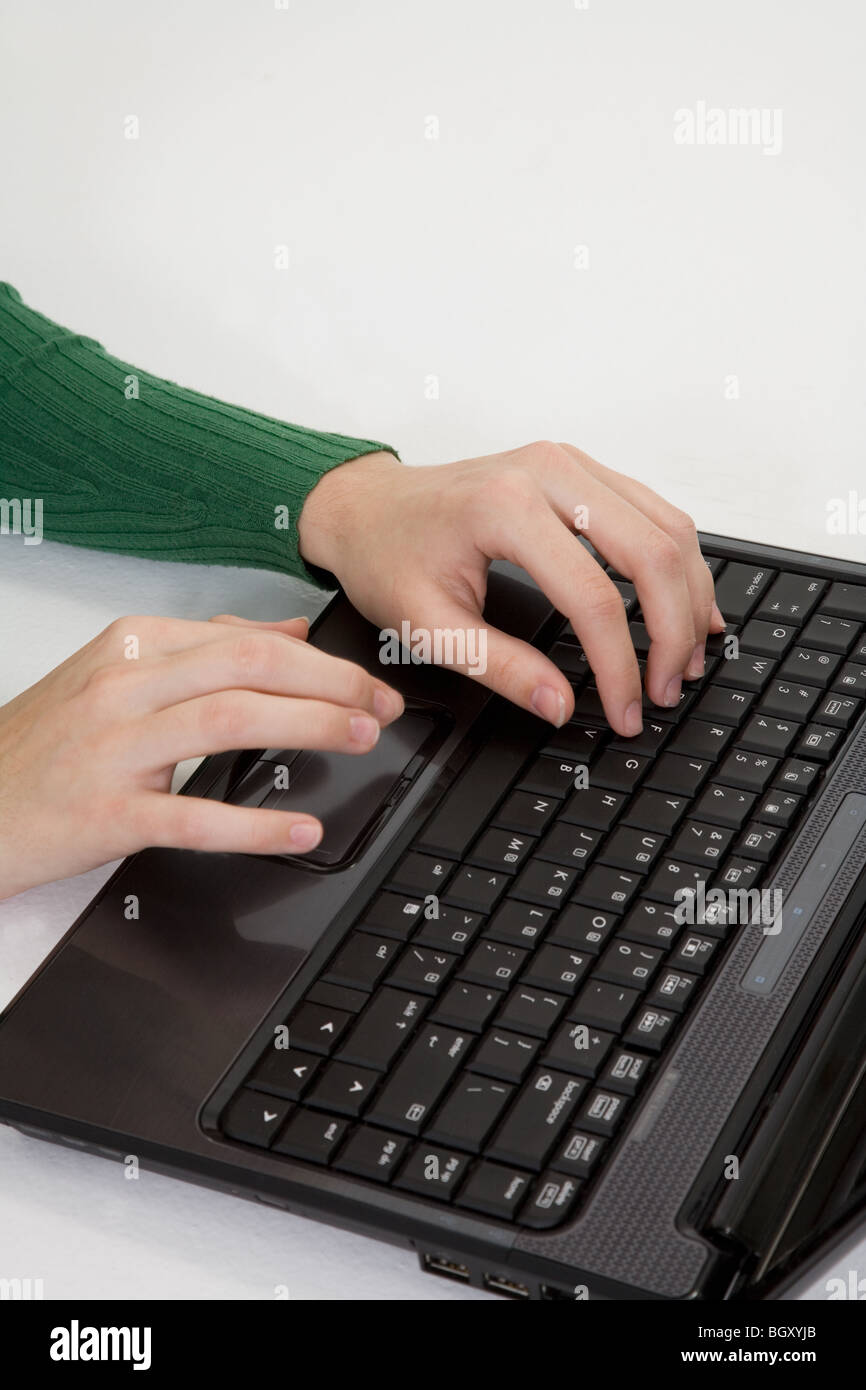 Young woman working on laptop computer on white background Banque D'Images