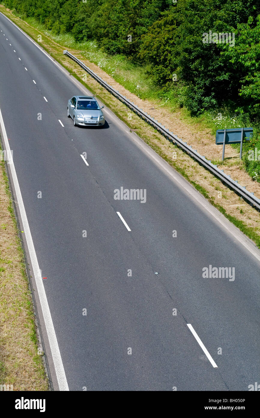 Voiture sur deux voies avec des lignes blanches dans le centre et crash barrier Banque D'Images