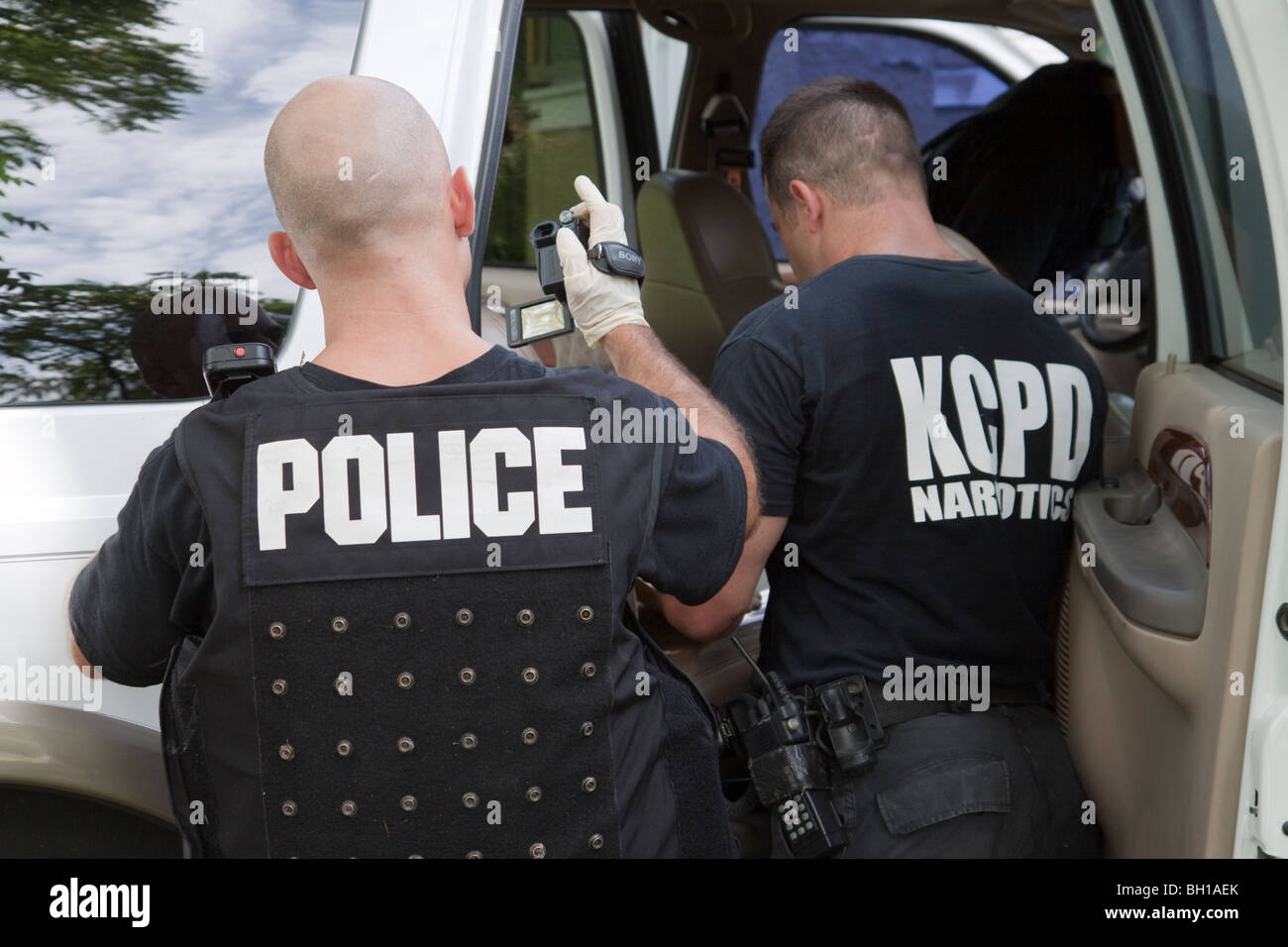 Les policiers du SWAT Team véhicule recherche de drogues, d'espèces et d'armes. Mandat de perquisition. L'Unité des stupéfiants de la rue. Banque D'Images