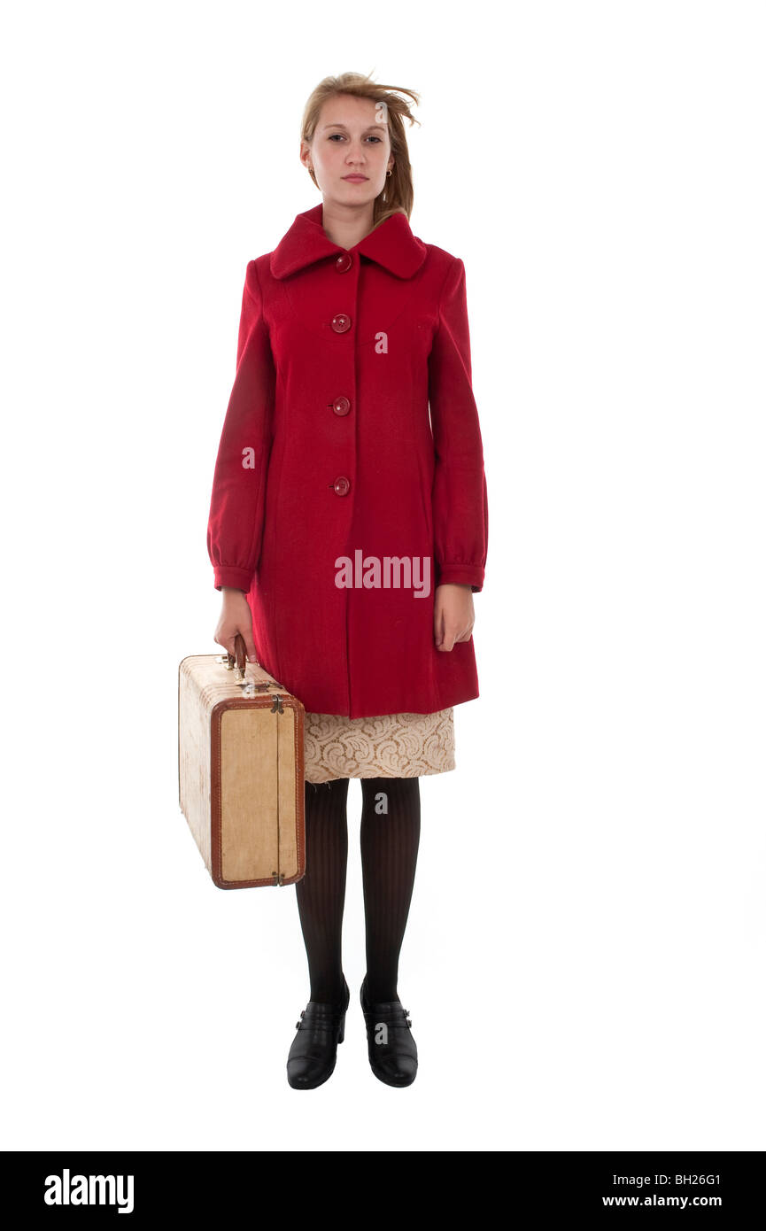 Teenage blonde Girl in red coat holding a suitcase Banque D'Images