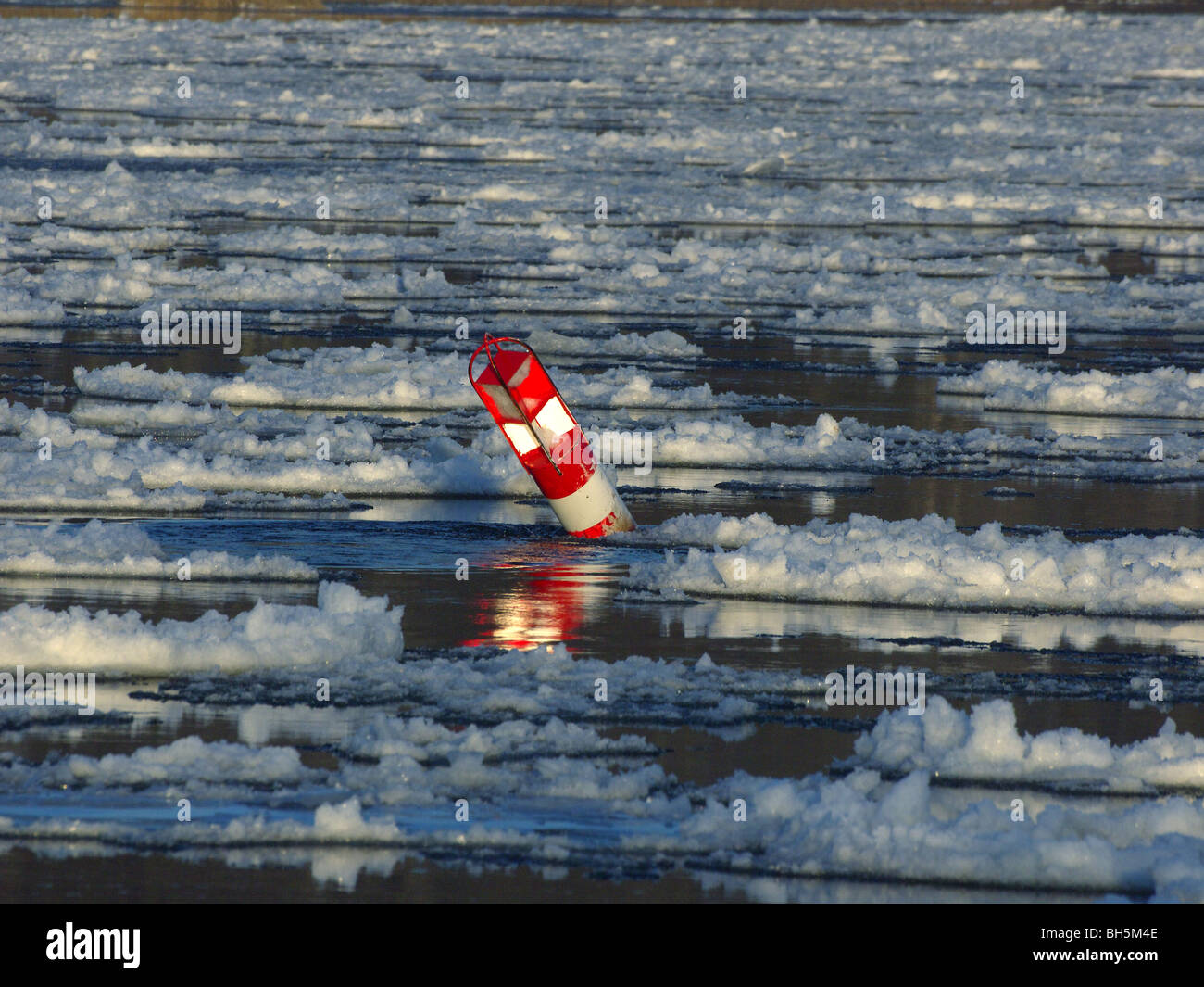 La bouée dans les glaces à la dérive sur l'Elbe près de Artlenburg, Allemagne du Nord. Banque D'Images