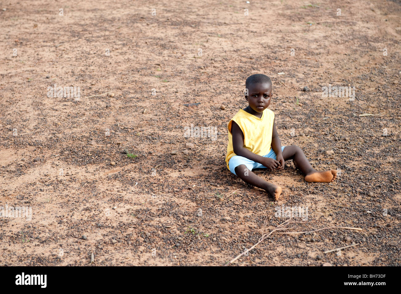 Enfant assis sur le plancher lors de réunion de village ville d'Ong Sierra Leone Banque D'Images
