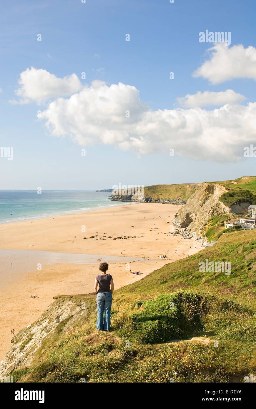Femme sur la falaise à la recherche sur la plage, côte, Baie de Watergate, Cornwall, sud de l'Angleterre, Royaume-Uni, Europe Banque D'Images