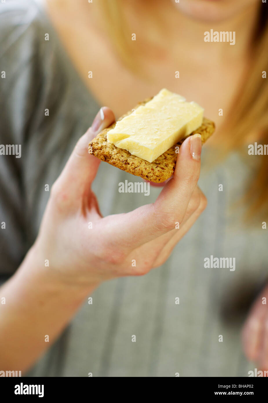 Girl eating cheese Banque D'Images