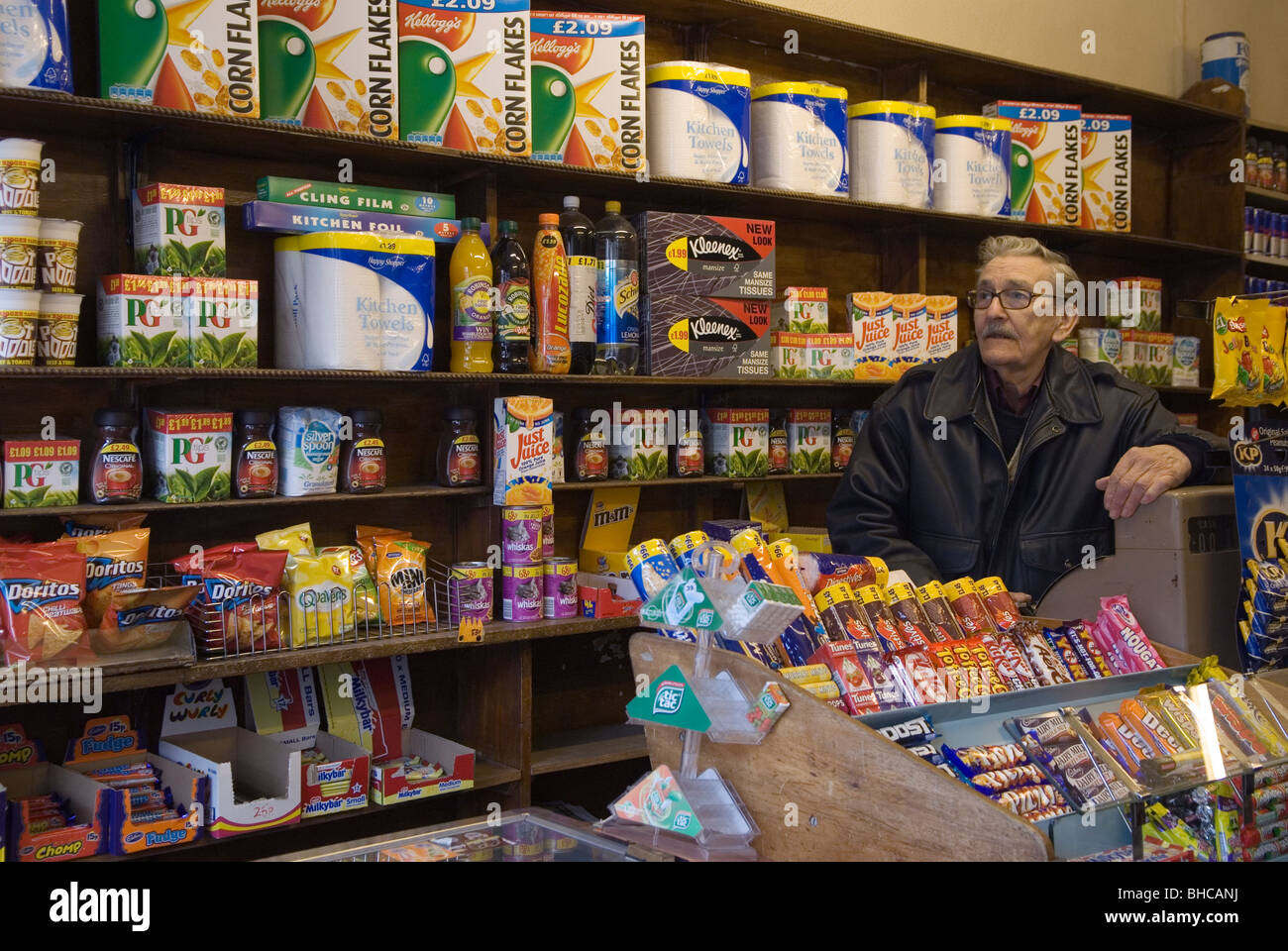 Gardien de magasin dans son magasin du coin à l'ancienne, le propriétaire David Brown s'appuyant sur la caisse. Brentwood Middlesex Londres 2010s 2010 UK HOMER SYKES Banque D'Images