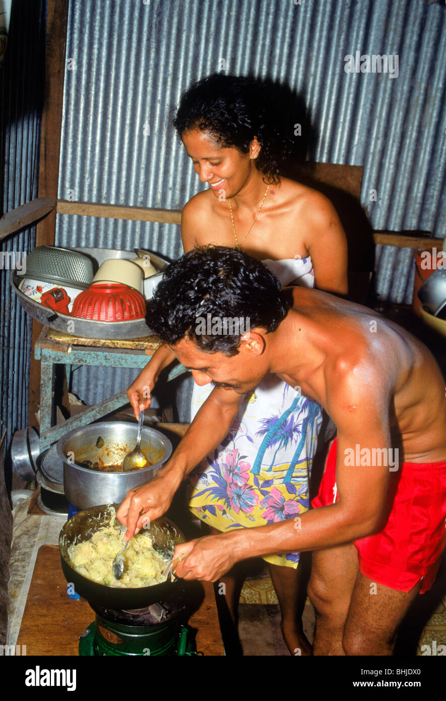 Frère et soeur de la cuisson et la préparation des aliments dans la cuisine typique à la maison sur l'île de La Digue aux Seychelles Banque D'Images