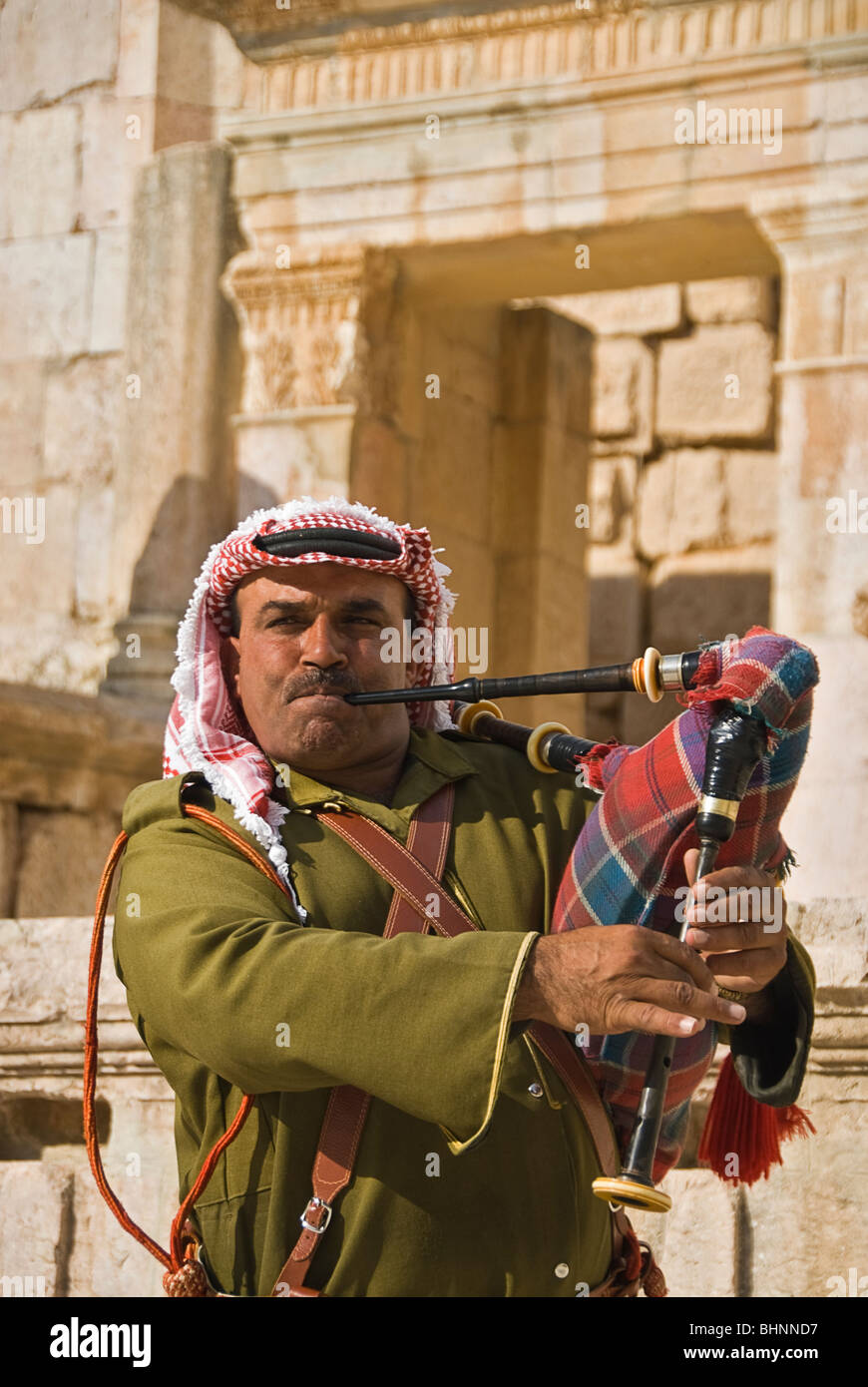 Man blowing le pipa à les vestiges romains de Jerash, Jordanie, Asie. Banque D'Images