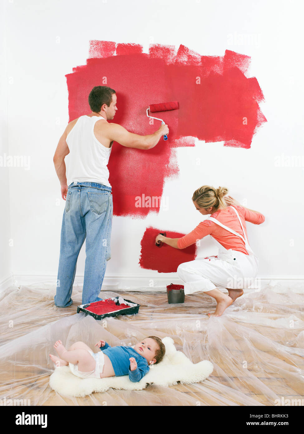 Couple peindre un mur, bébé sur marbre Banque D'Images