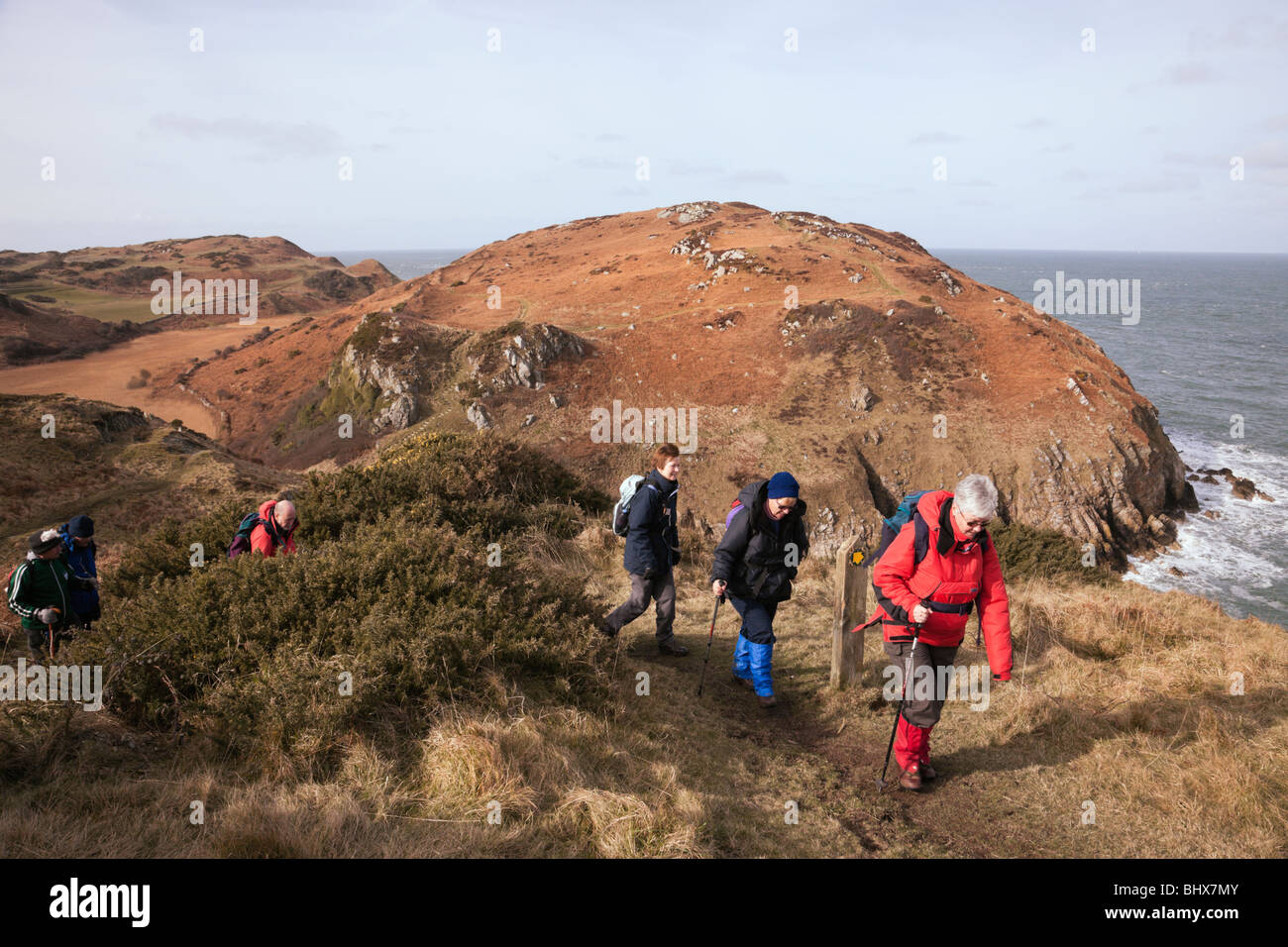 Les promeneurs marchant sur l'île d'Anglesey sentier littoral au-dessus de Porth, Cynfor. Cemaes, Isle of Anglesey, au nord du Pays de Galles, Royaume-Uni. Banque D'Images