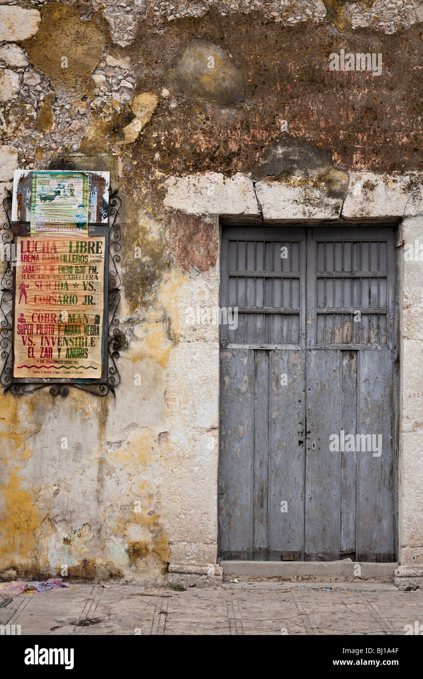 La lutte et la tauromachie : Lucha Libre. Deux affiches en compétition pour l'attention sur un mur bien survécu à Merida. Banque D'Images