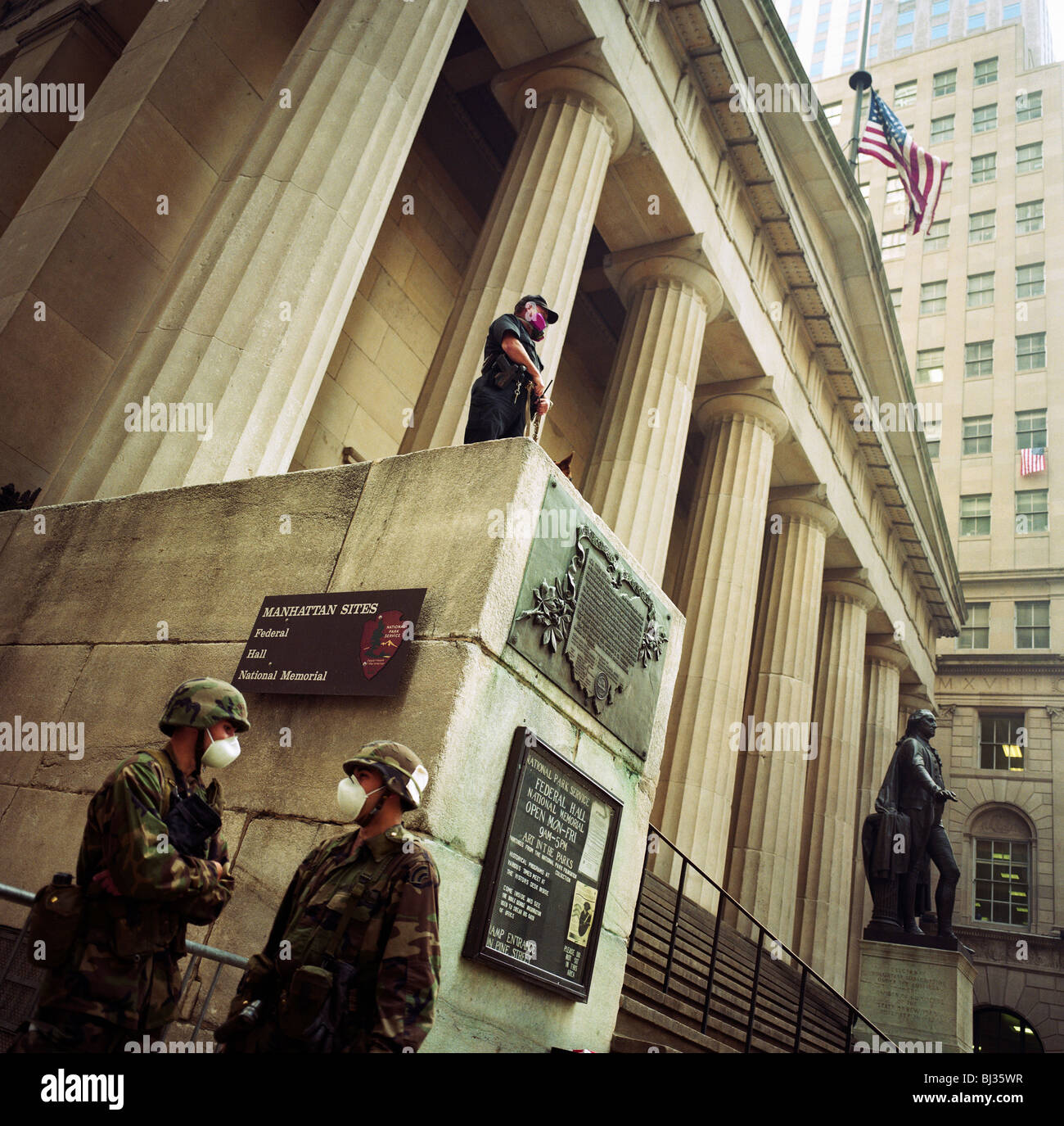Des soldats de la Garde nationale porter un masque anti-poussière et de garde le haut des colonnes du Federal Hall à Wall Street. Banque D'Images
