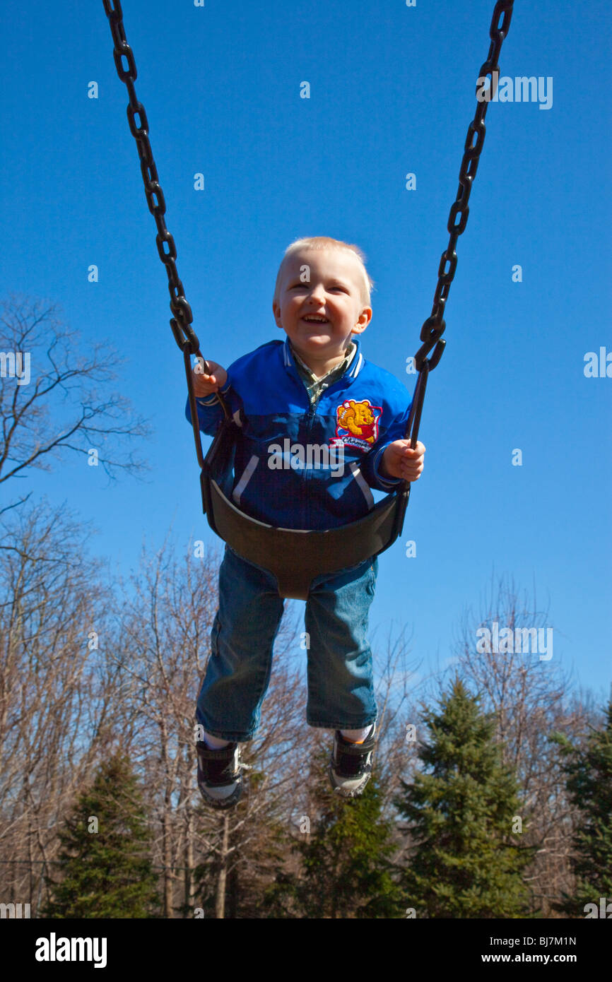 Jeune garçon sur une balançoire à un parc à South Orange, New Jersey Banque D'Images