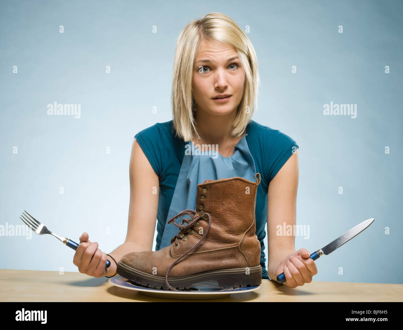 Woman eating a boot Banque D'Images