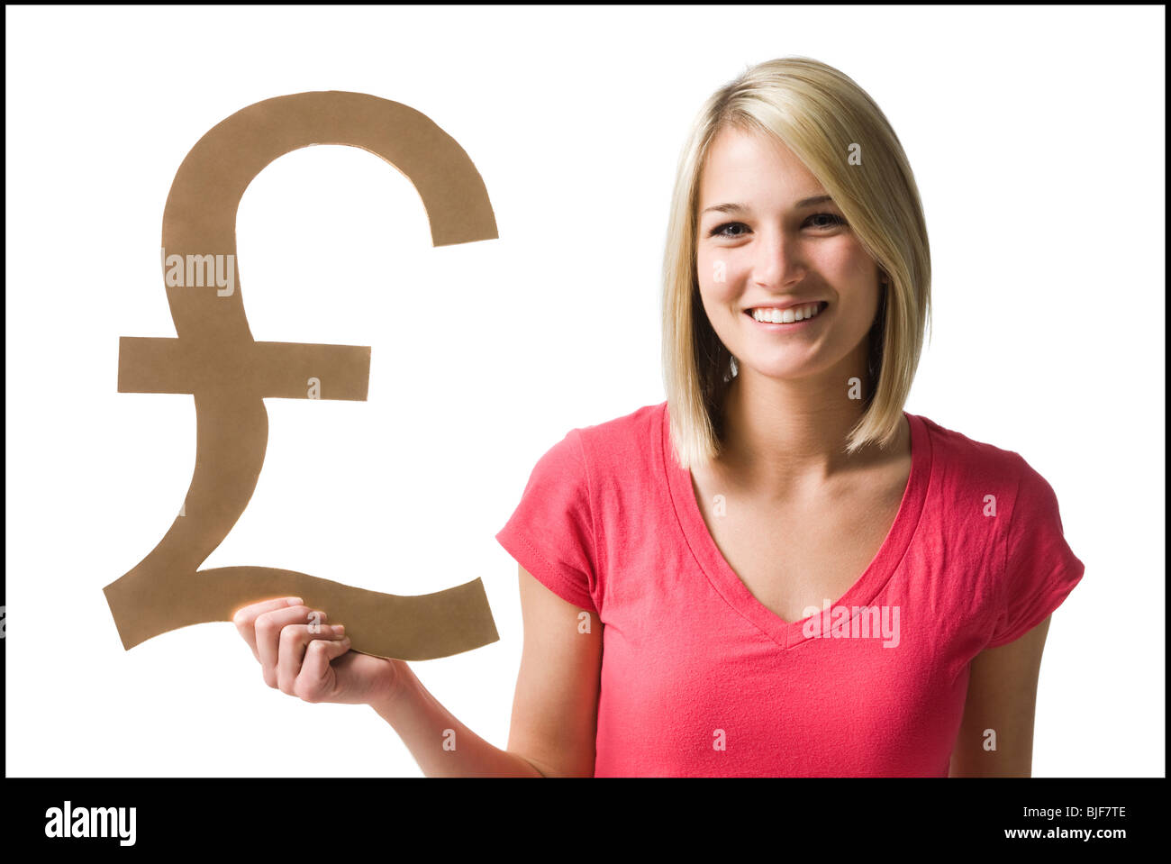 Woman holding up British pound symbol Banque D'Images