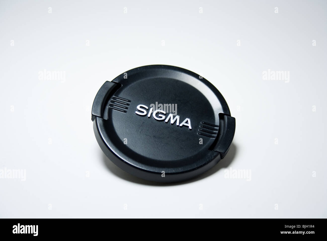 L'objectif sigma lense casquette noire logo marque produit macro closeup Banque D'Images