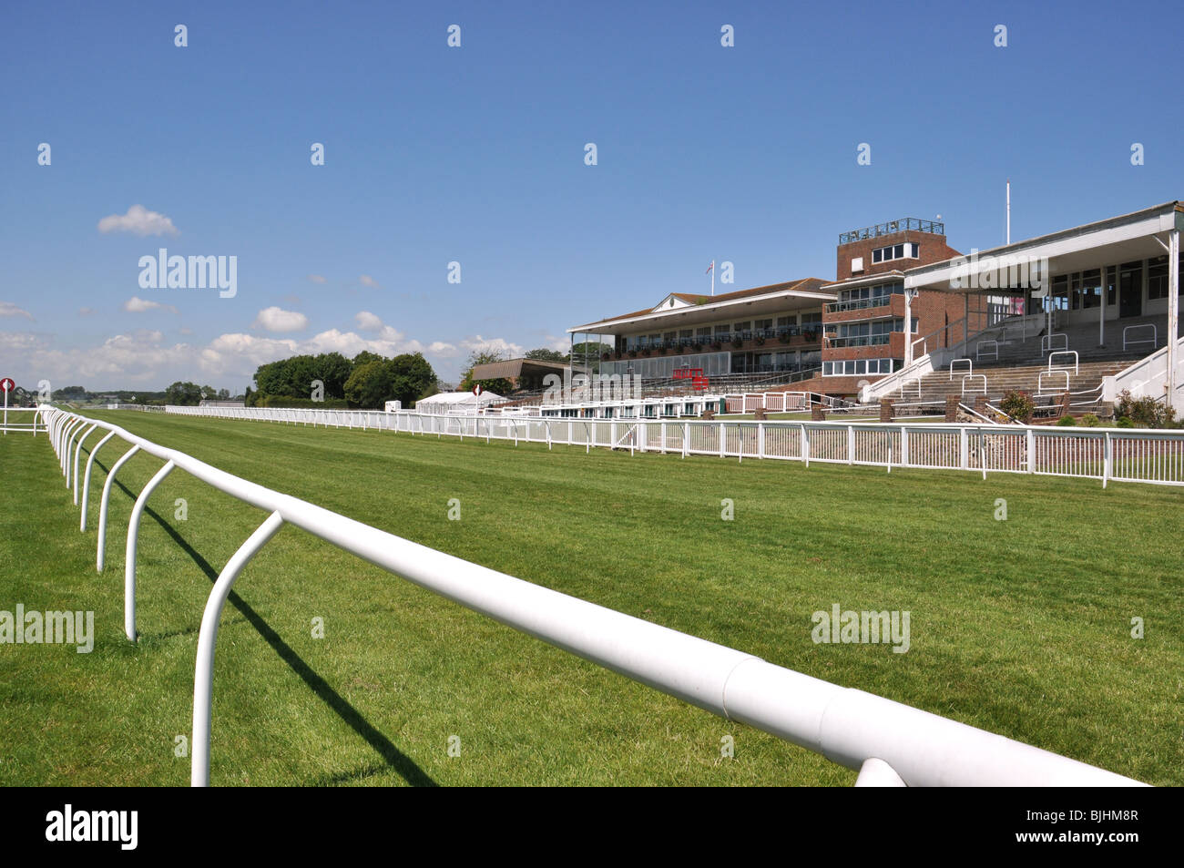 Folkestone, Kent, UK. Hippodrome de course de chevaux dernière droite et grande tribune Banque D'Images