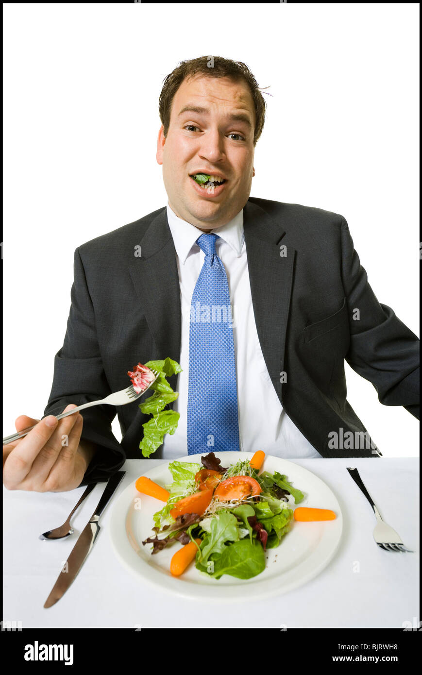 L'excès de businessman eating a salad le déjeuner Banque D'Images