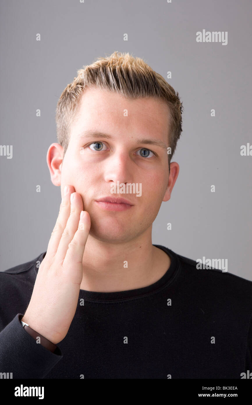 Homme, 23 ans, portrait, rasé de près, le contrôle se raser avec sa main  Photo Stock - Alamy