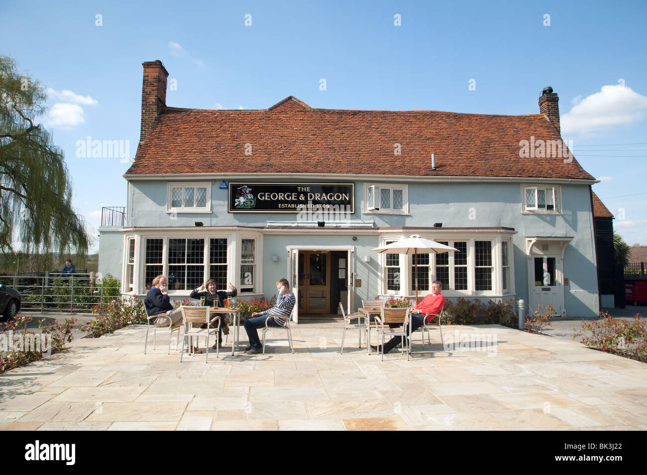 Les gens assis à l'extérieur de l'alcool, le George & Dragon pub, Blackmore, Essex, UK Banque D'Images