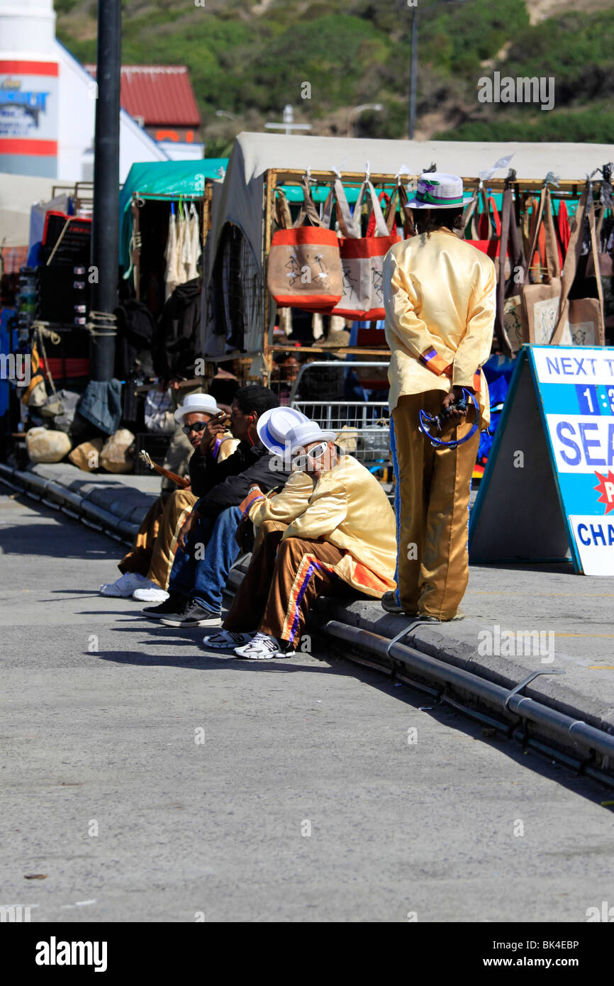 Les hommes vêtus de costumes aux couleurs vives de Cape Minstrels (klopse) au port de Hout Bay. Banque D'Images