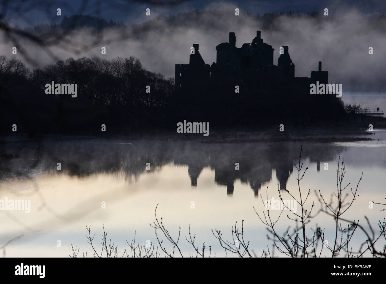 Kilchurn Castle sur les rives du Loch Awe, Ecosse, enveloppée de brouillard tôt le matin Banque D'Images