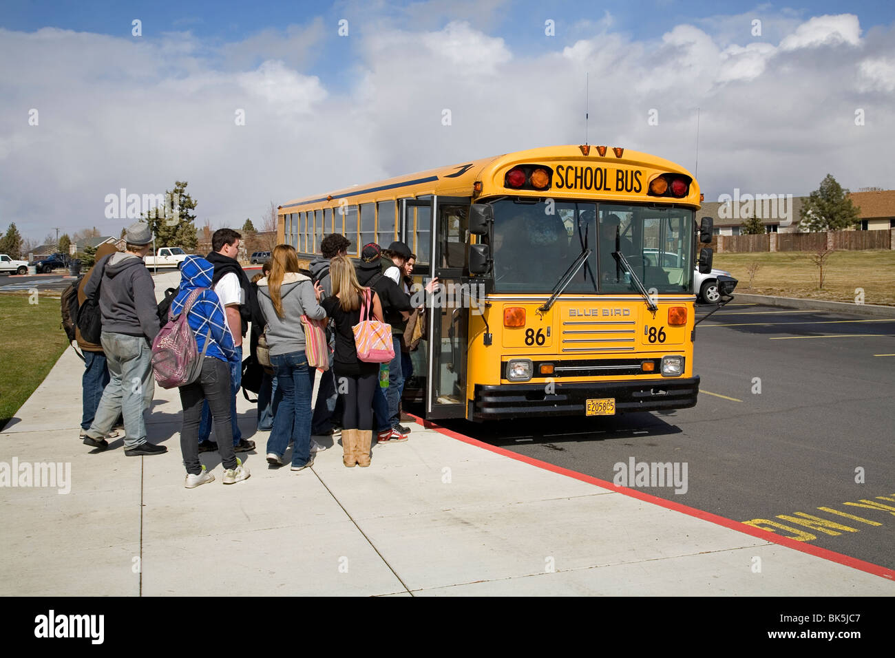 Les élèves du secondaire à bord d'un autobus scolaire pour le voyage de retour de l'école Banque D'Images