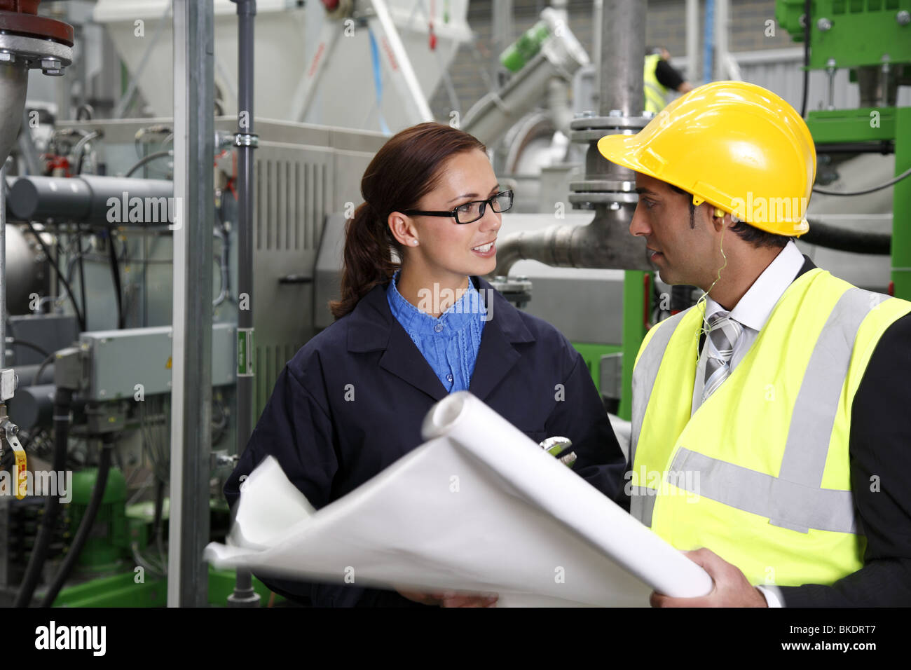 Femme travailleur industriel, à une réunion avec l'Asian male directeur d'usine. Banque D'Images