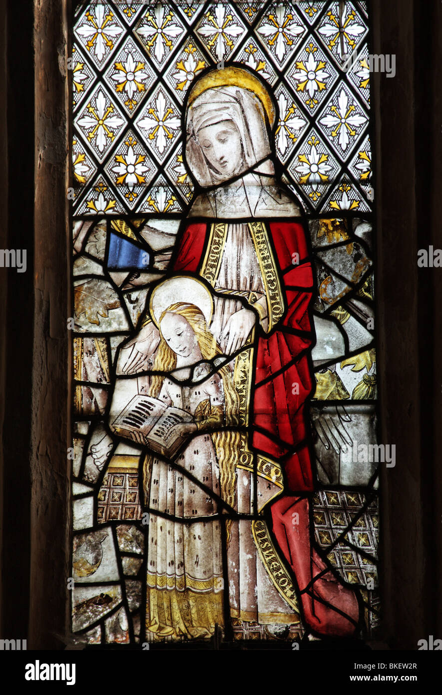 Un vitrail médiéval représentant Sainte Anne enseignant la Vierge Marie à lire Banque D'Images