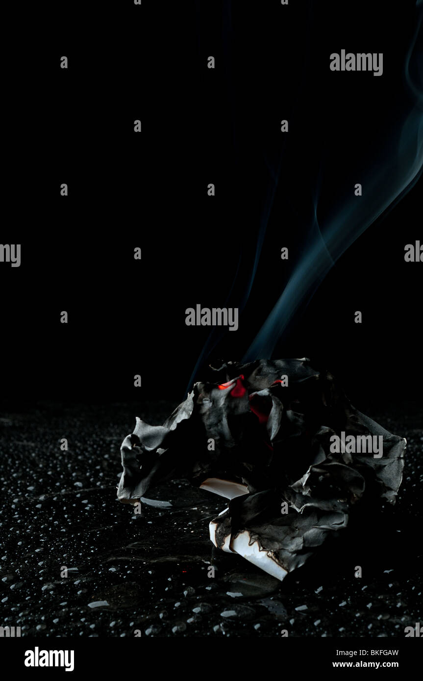 La braise qui couve d'un papier en feu éteint Banque D'Images