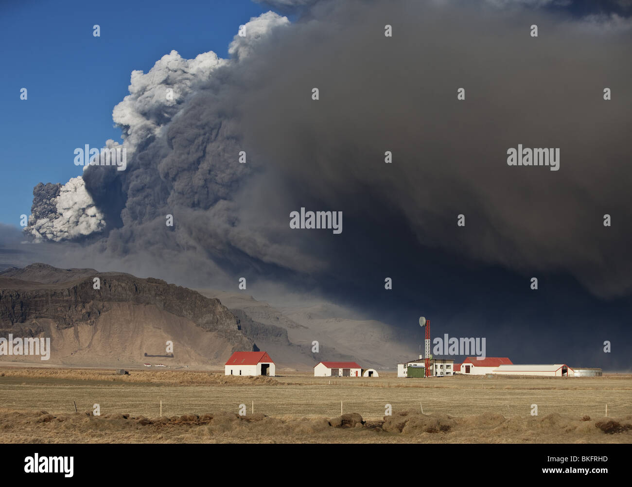 Ferme avec nuage de cendres volcaniques l'éruption du volcan de Eyjafjallajokull, en Islande. Banque D'Images