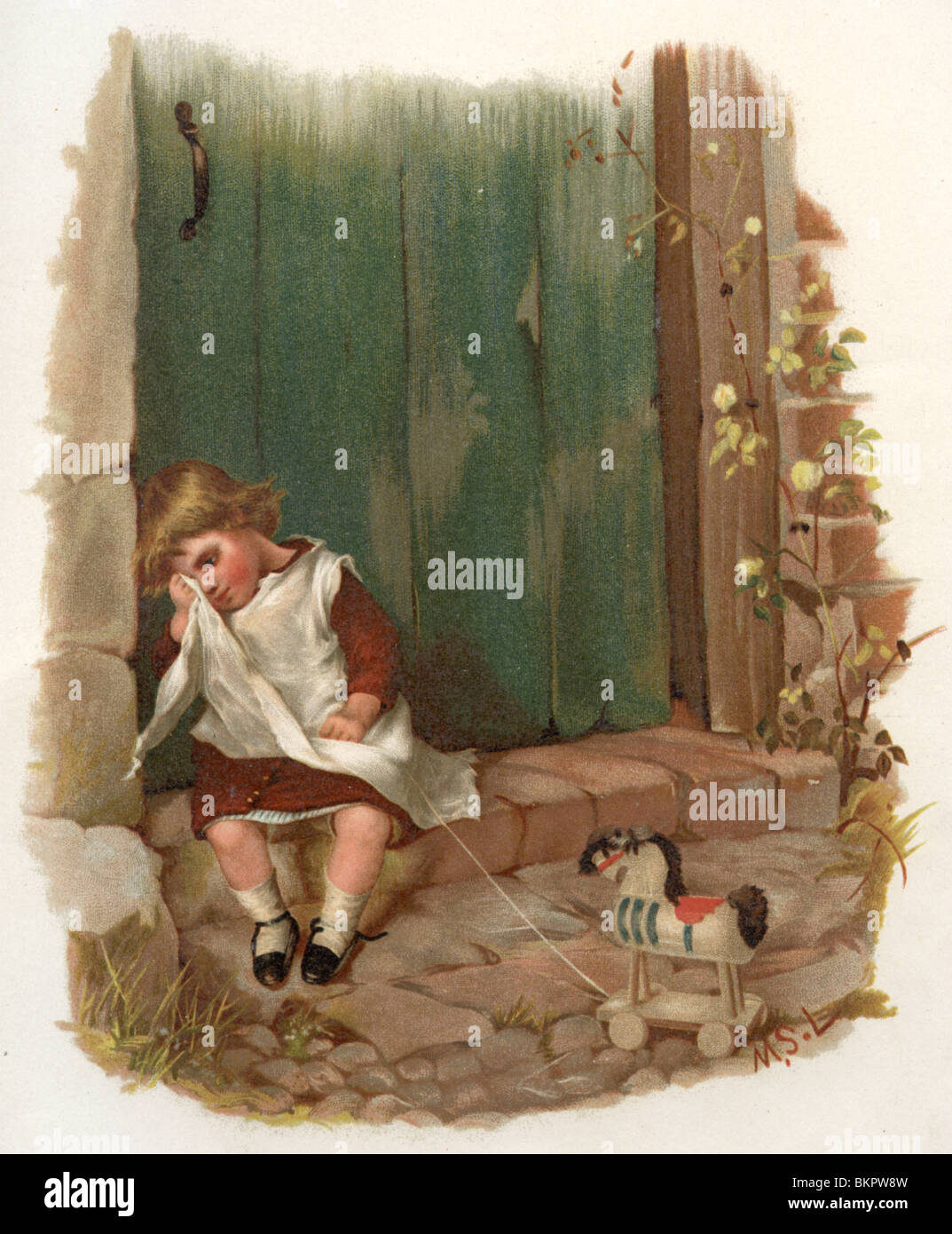 Petite fille s'assit sur le pas de la porte, en essuyant ses larmes Banque D'Images