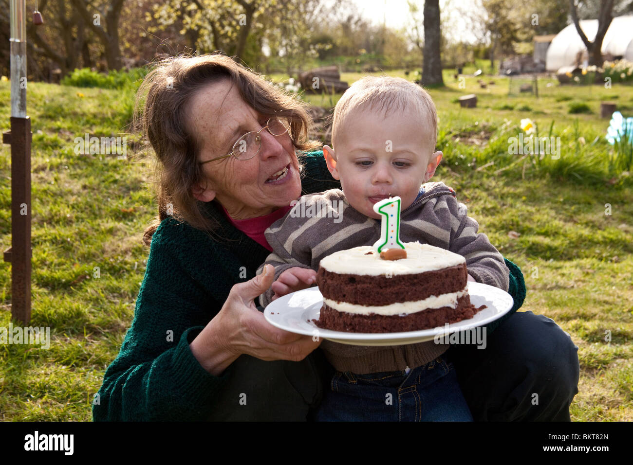 Bebe Garcon Age D Un An A L Exterieur Avec Son Gateau D Anniversaire Et Grand Mere Hampshire Angleterre Royaume Uni Photo Stock Alamy