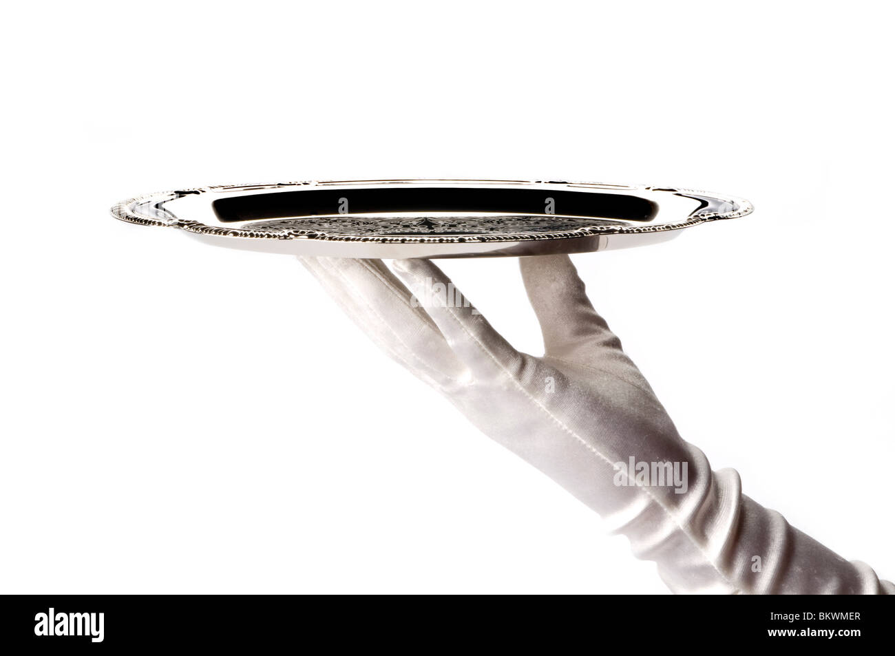 Hand holding silver tray Banque D'Images