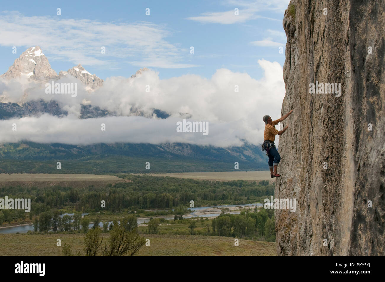 Un homme escalade une paroi rocheuse au-dessous de la queue noire, Tetons Butte, Jackson, Wyoming. Banque D'Images