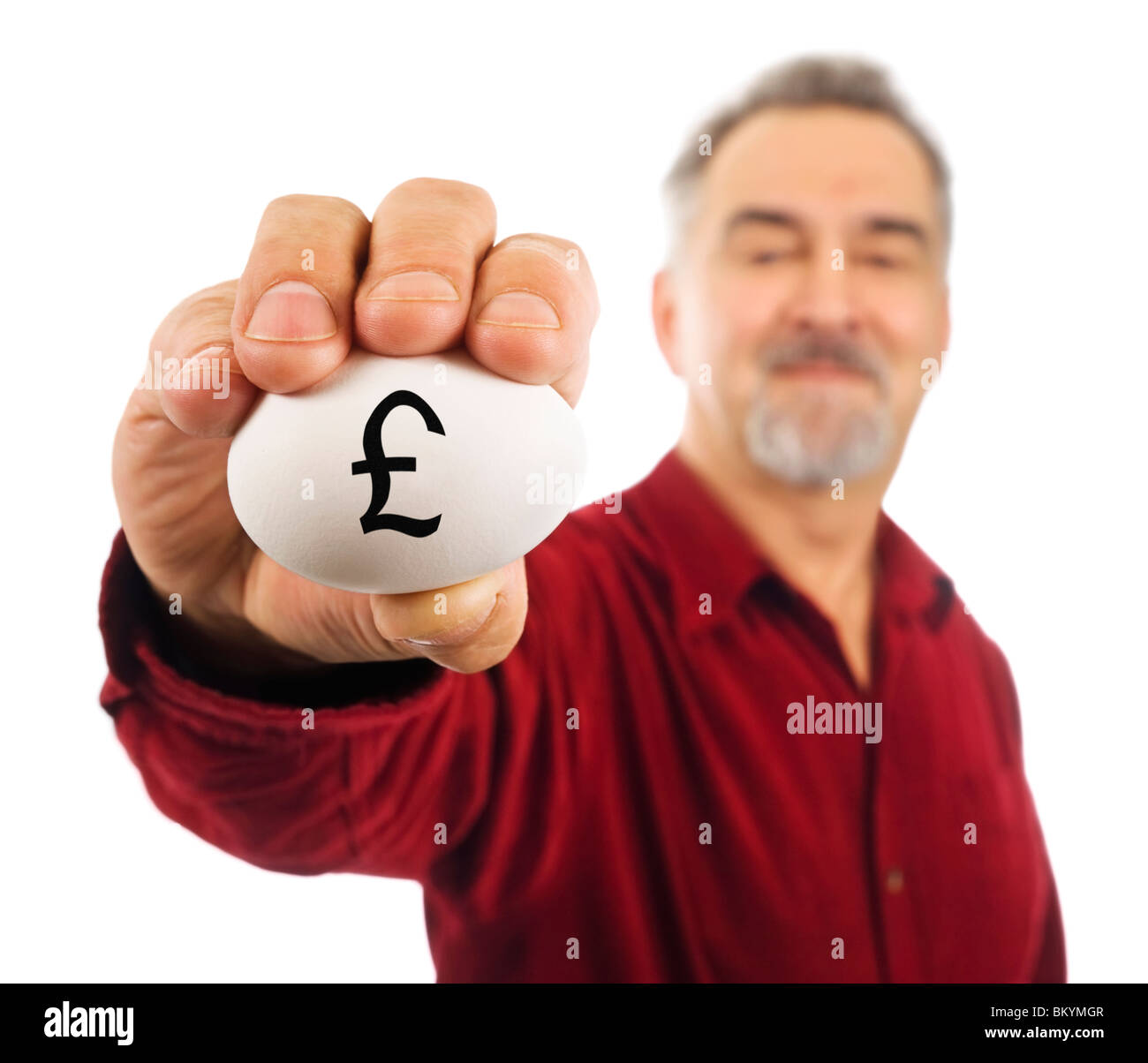 L'homme blanc est titulaire d'œuf avec le symbole de livre sterling (£) écrit dessus, symbolisant l'argent fragile, le fameux 'pécule.' Banque D'Images